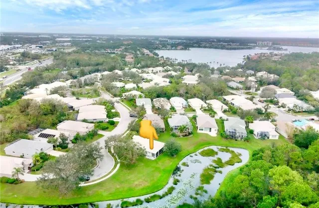 an aerial view of a house with a lake view