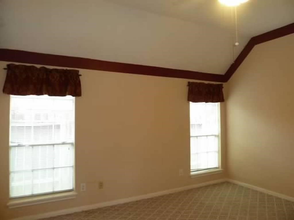 4542 Springfield Lakes Street Sugar Land, TX 77479 - Photo 10 of 16 Spacious secondary bedroom with crown molding and large windows for natural light.