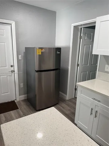 a kitchen with a refrigerator freezer and a stove top oven