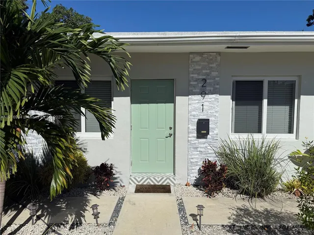 a view of a house with a potted plant