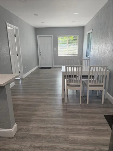 a view of dining room with wooden floor and window