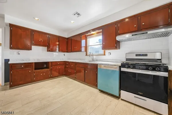 a kitchen with a sink stove and cabinets