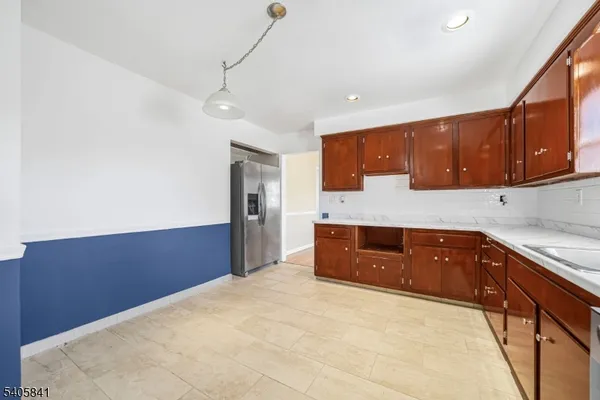 a kitchen with stainless steel appliances granite countertop a refrigerator and stove