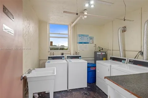 a view of storage and utility room with two washing machine