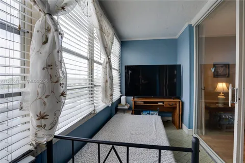 a view of a room with furniture and window