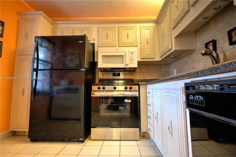 a kitchen with stainless steel appliances granite countertop a refrigerator and a stove