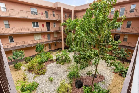 a view of a brick building next to a yard