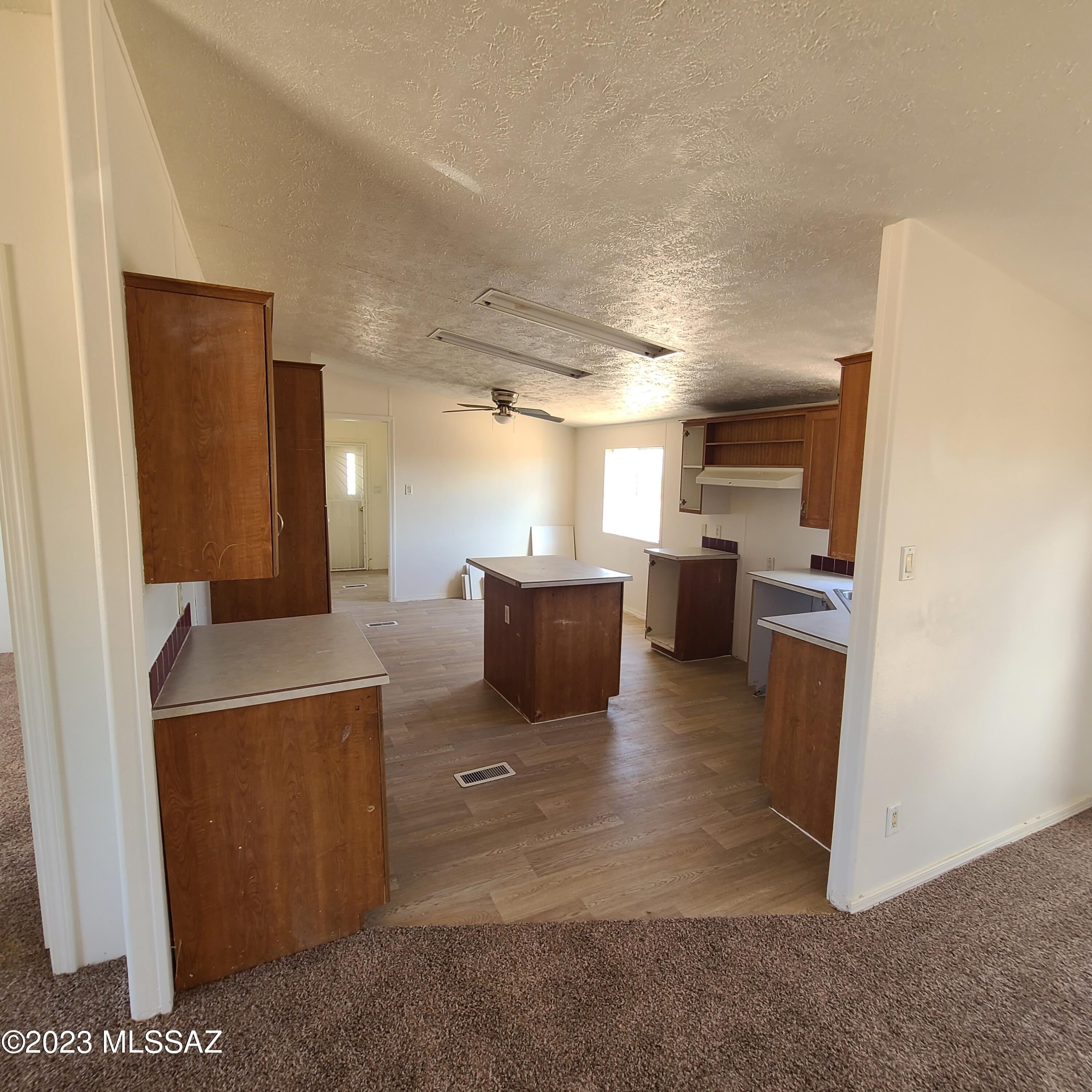 8896 South Marstellar Road Tucson, AZ 85736 - Photo 9 of 39 a living room with furniture and a flat screen tv