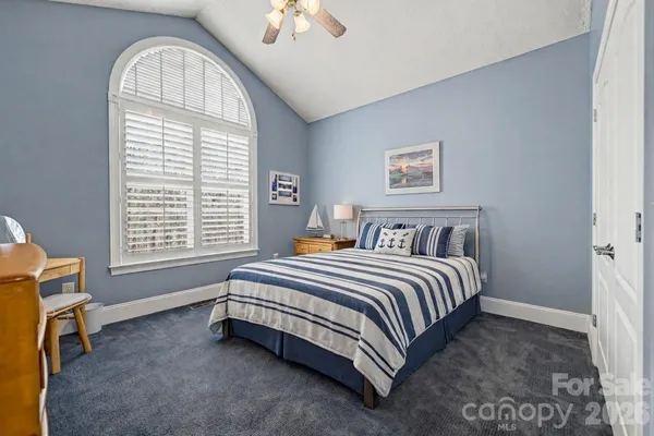 a spacious bedroom with a bed and a window