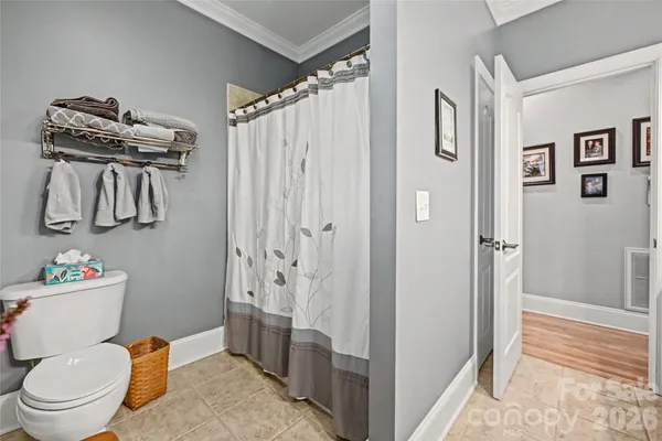 a bathroom with a toilet a sink and shower