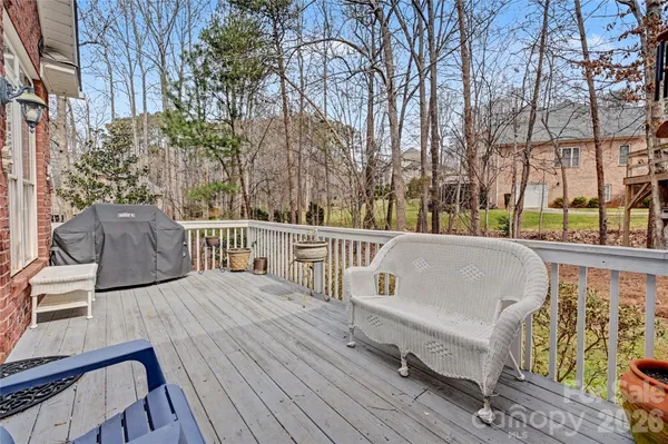 a view of balcony with wooden floor and outdoor seating