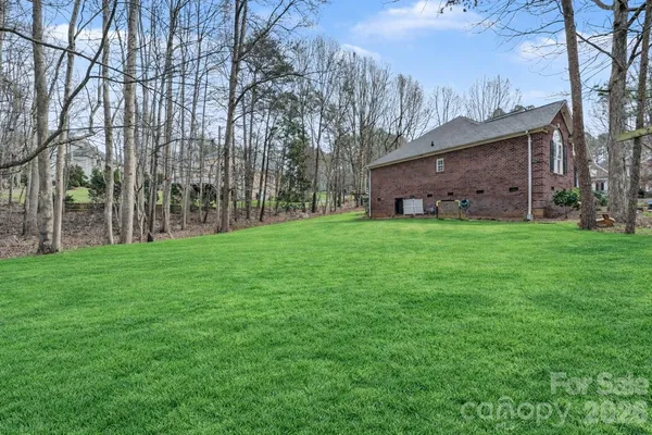 a view of a yard with a house in the background