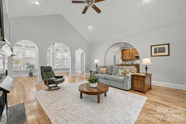 a living room with furniture a rug and a chandelier