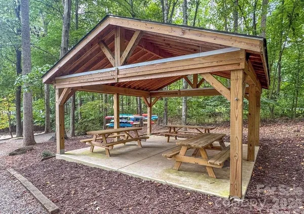 a view of a patio with a table chairs and a backyard