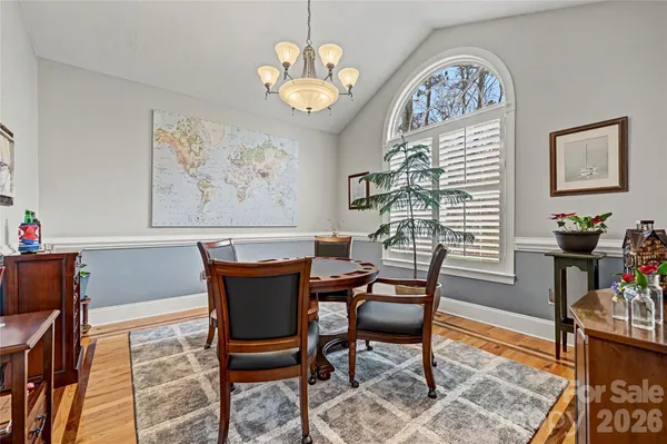 a view of a dining room with furniture and a chandelier