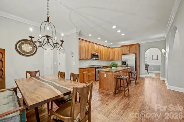 a view of a dining room with furniture wooden floor and a clock