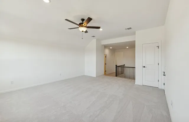 an empty room with wooden floor and entryway