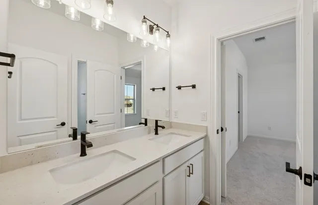 a bathroom with a sink a toilet and a shower