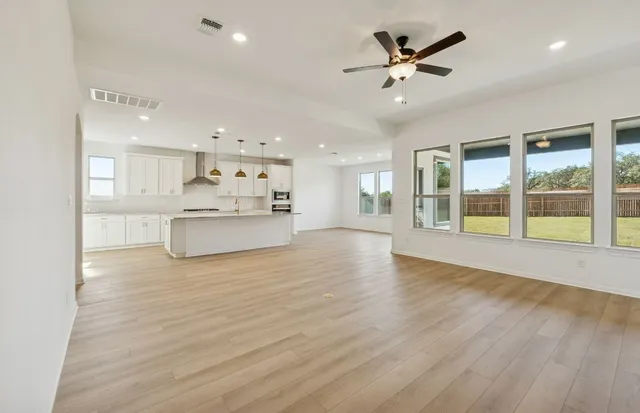 a picture of a kitchen with a table and chairs