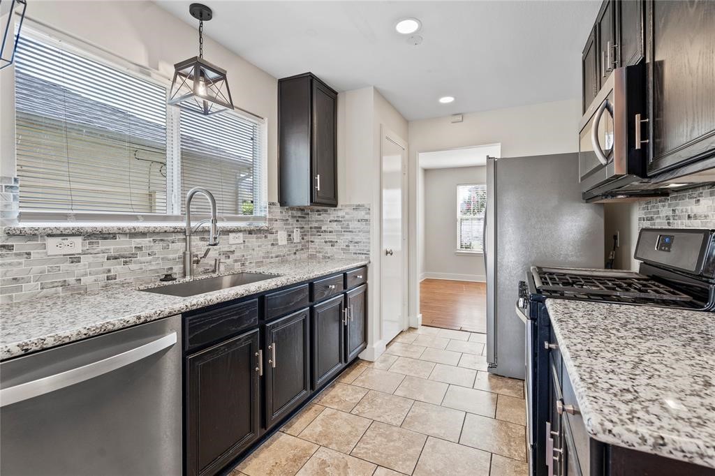20729 Patriot Park Lane Katy, TX 77449 - Photo 7 of 39 a kitchen with stainless steel appliances granite countertop a sink stove and refrigerator