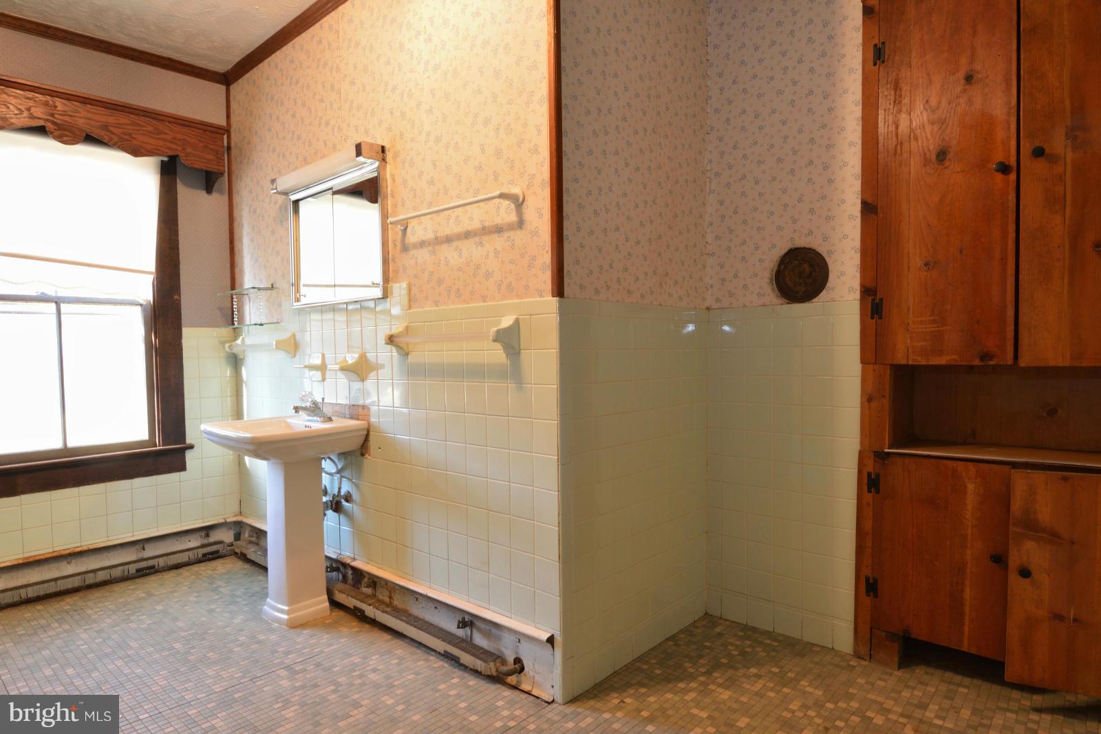 4479 Courtneys Corner Road Sumerduck, VA 22742 - Photo 12 of 30 a bathroom with a sink and a mirror