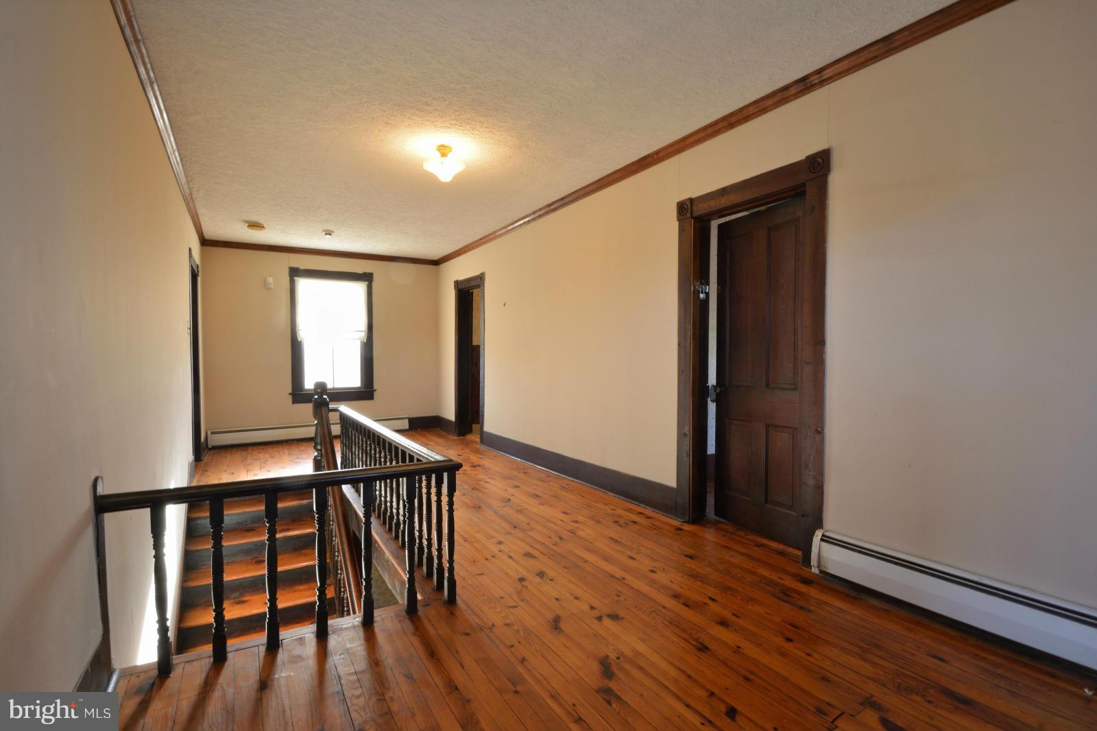 4479 Courtneys Corner Road Sumerduck, VA 22742 - Photo 21 of 30 a view of an empty room with wooden floor and stairs
