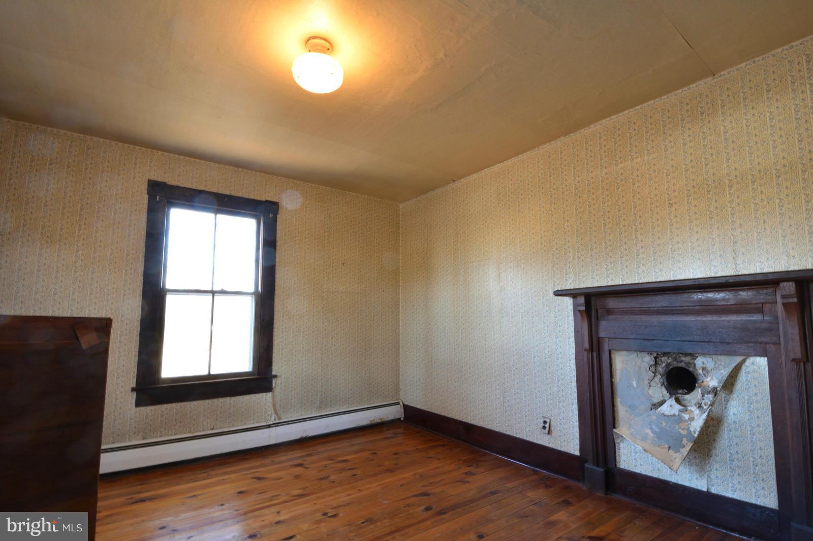 4479 Courtneys Corner Road Sumerduck, VA 22742 - Photo 22 of 30 a view of an empty room with wooden floor and a window