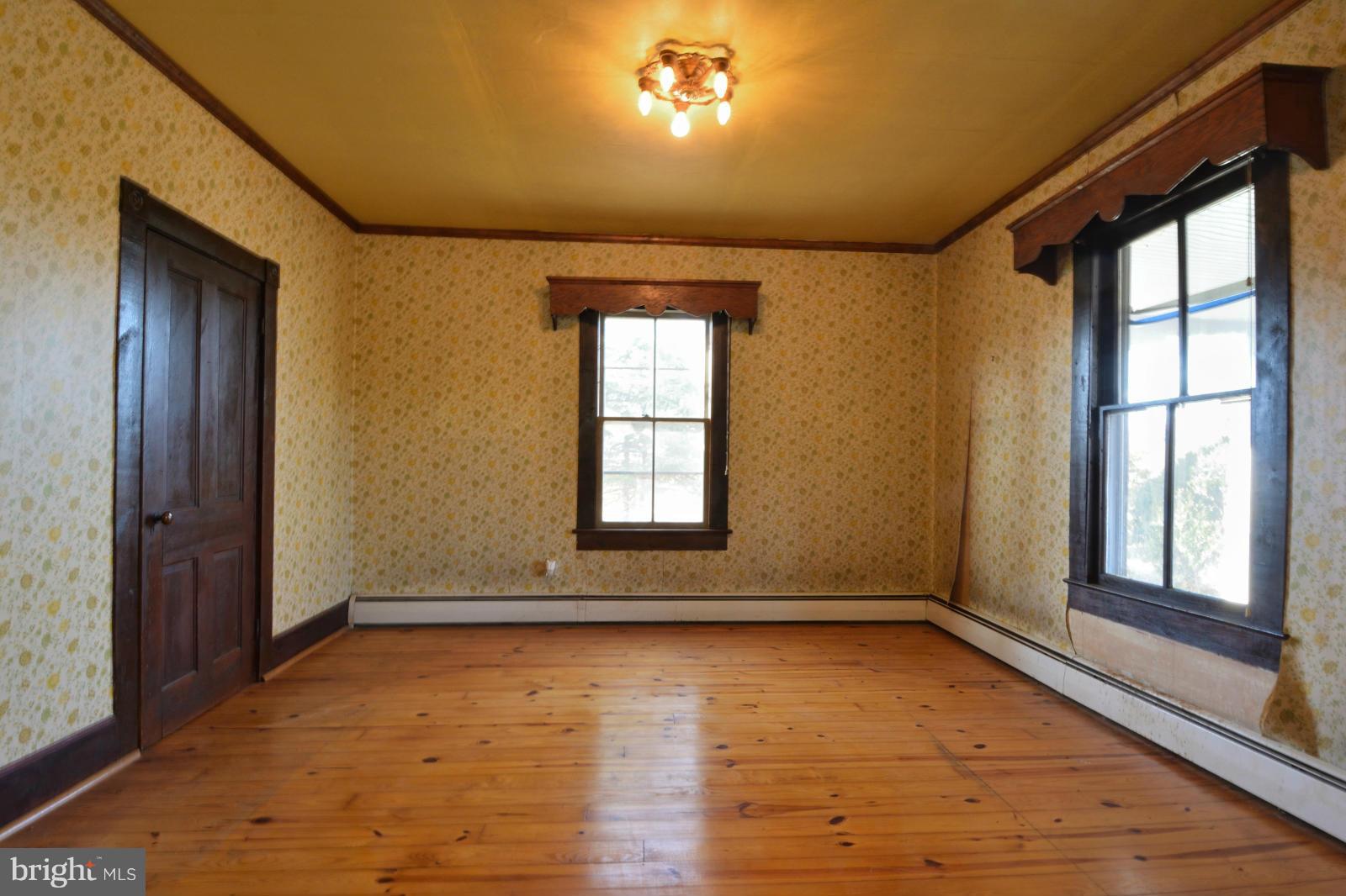 4479 Courtneys Corner Road Sumerduck, VA 22742 - Photo 8 of 30 a view of empty room with wooden floor and fan