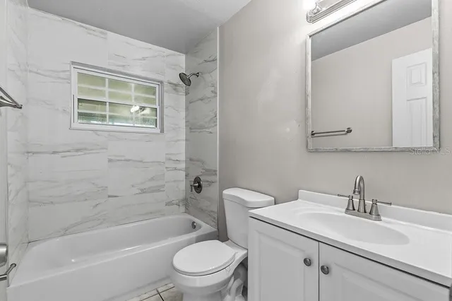 a bathroom with a sink toilet a mirror and shower