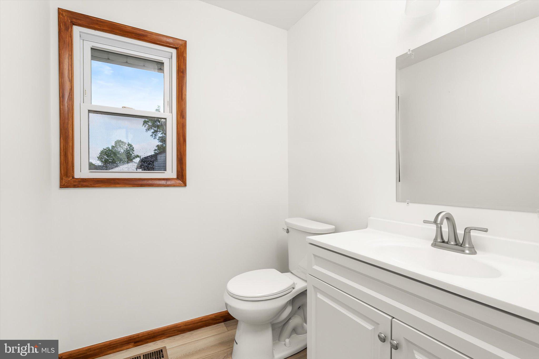 10 Whitman Road Hamilton, NJ 08619 - Photo 11 of 28 a bathroom with a toilet a sink and mirror