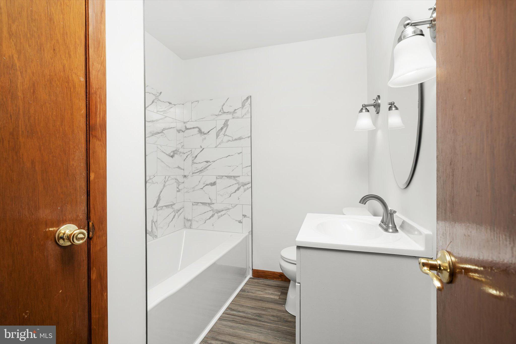 10 Whitman Road Hamilton, NJ 08619 - Photo 18 of 28 a bathroom with a sink and mirror with bathtub
