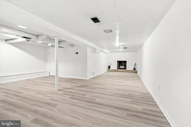 a view of a room with wooden floor