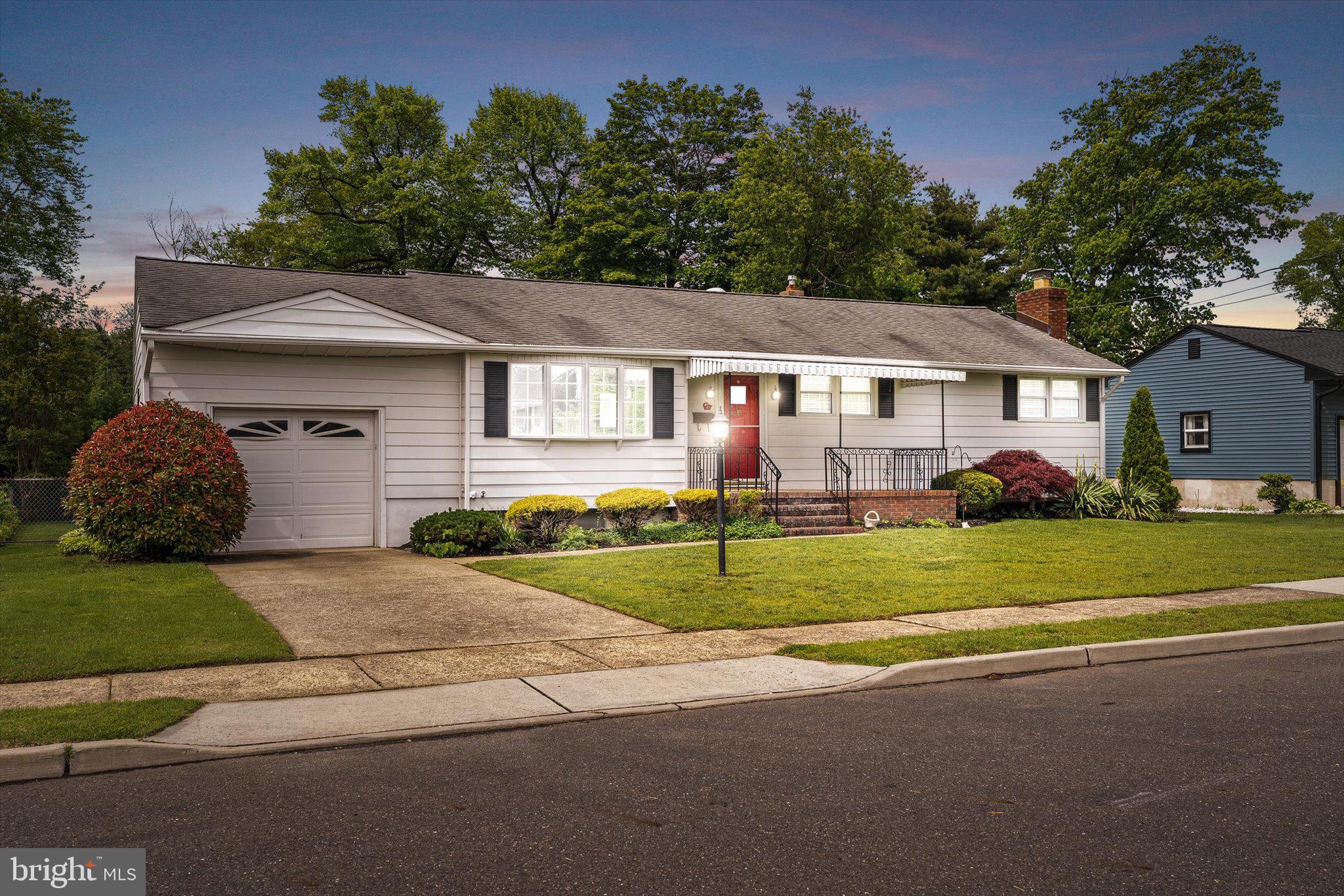 10 Whitman Road Hamilton, NJ 08619 - Photo 2 of 28 a front view of a house with a garden and plants