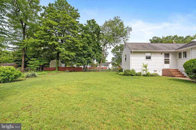 a front view of house with yard and trees