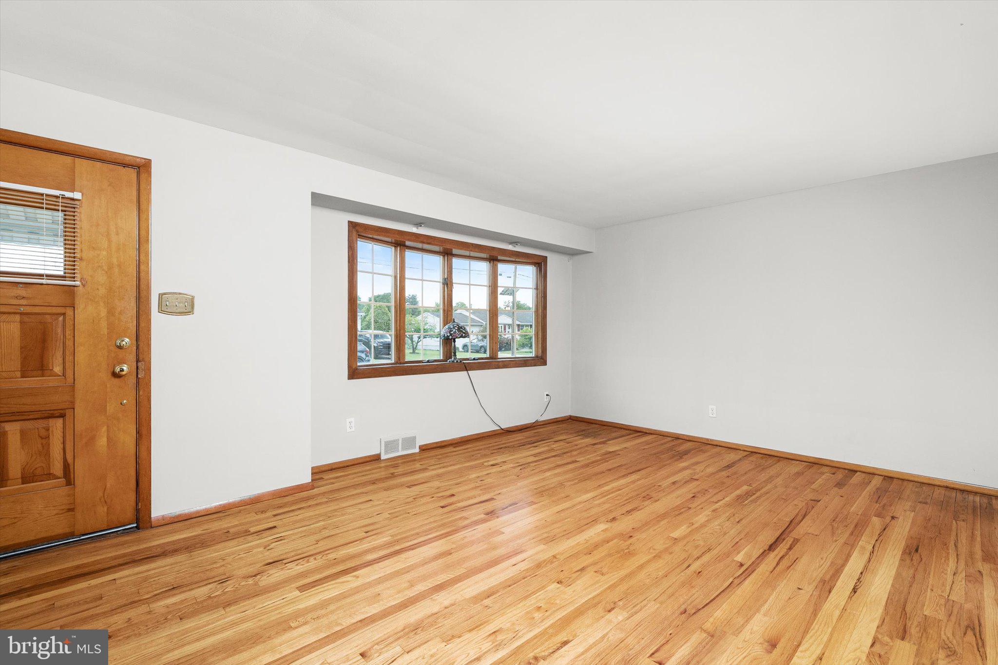 10 Whitman Road Hamilton, NJ 08619 - Photo 4 of 28 a view of empty room with wooden floor and fan