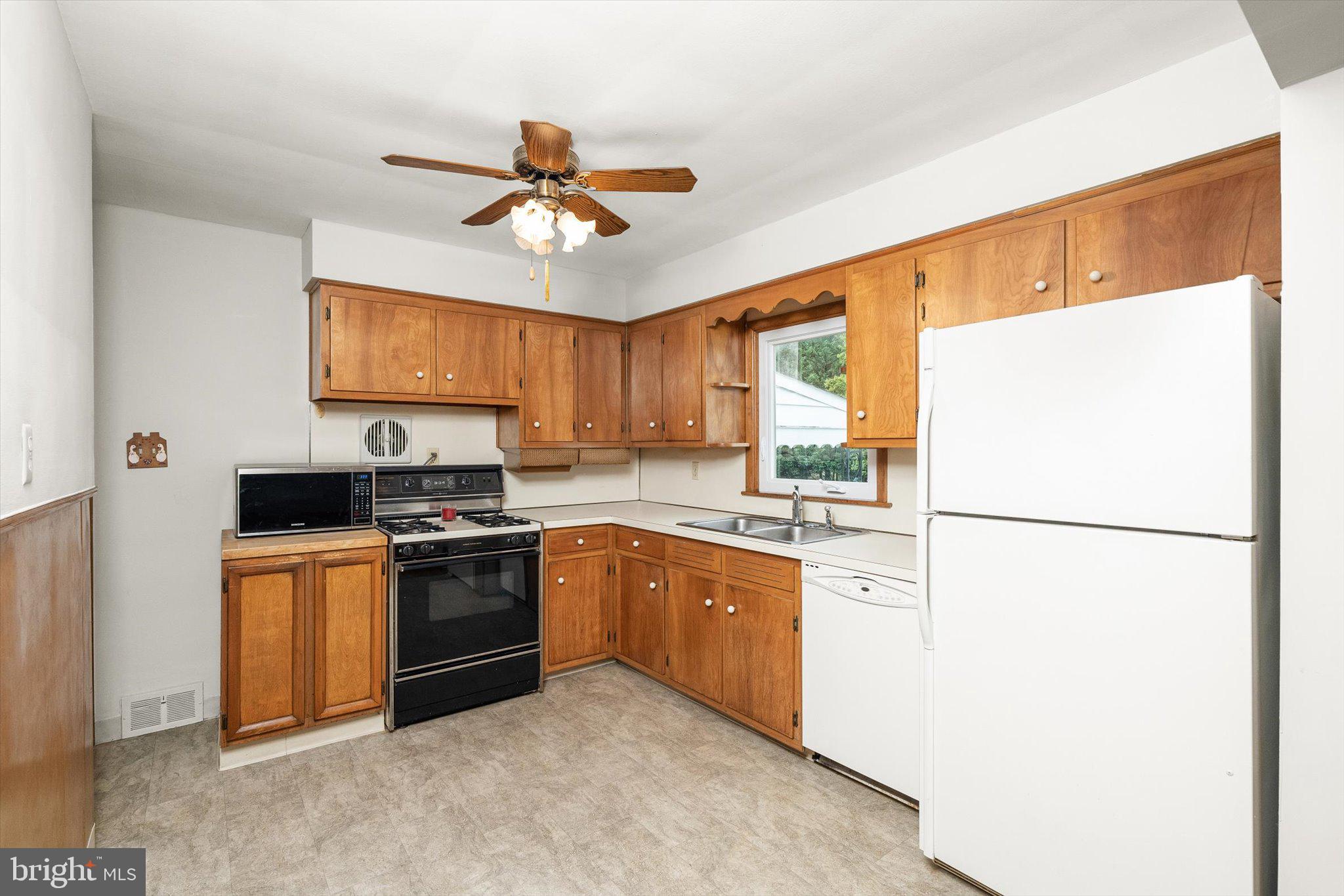 10 Whitman Road Hamilton, NJ 08619 - Photo 8 of 28 a kitchen with stainless steel appliances granite countertop a refrigerator a stove a sink and a refrigerator