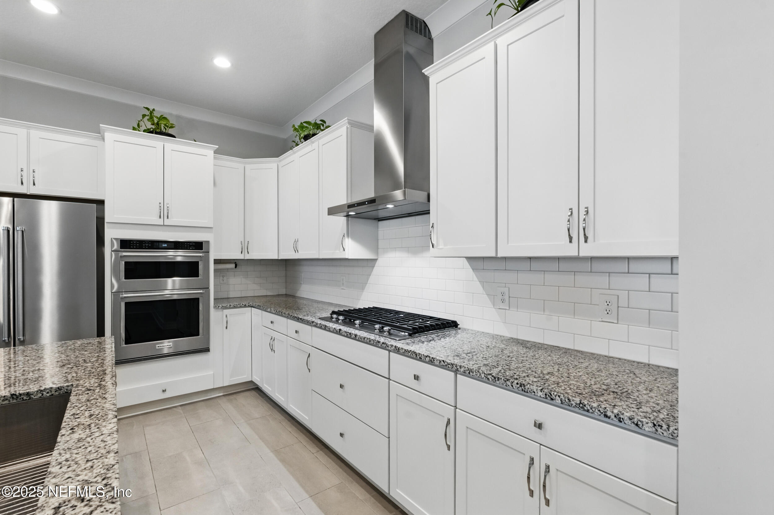 9918 Filament Boulevard Jacksonville, FL 32256 - Photo 13 of 106 a kitchen with granite countertop a sink stainless steel appliances and cabinets