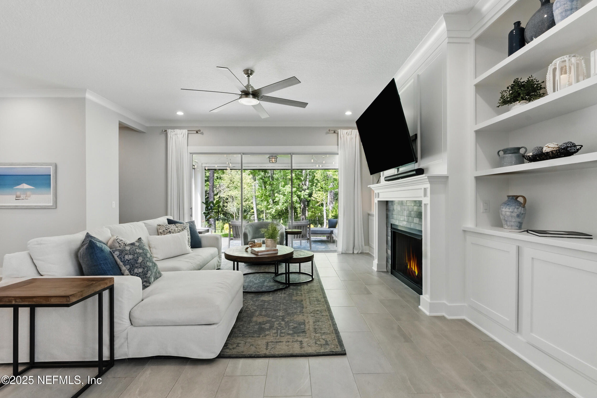 9918 Filament Boulevard Jacksonville, FL 32256 - Photo 17 of 106 a living room with furniture fireplace and a flat screen tv
