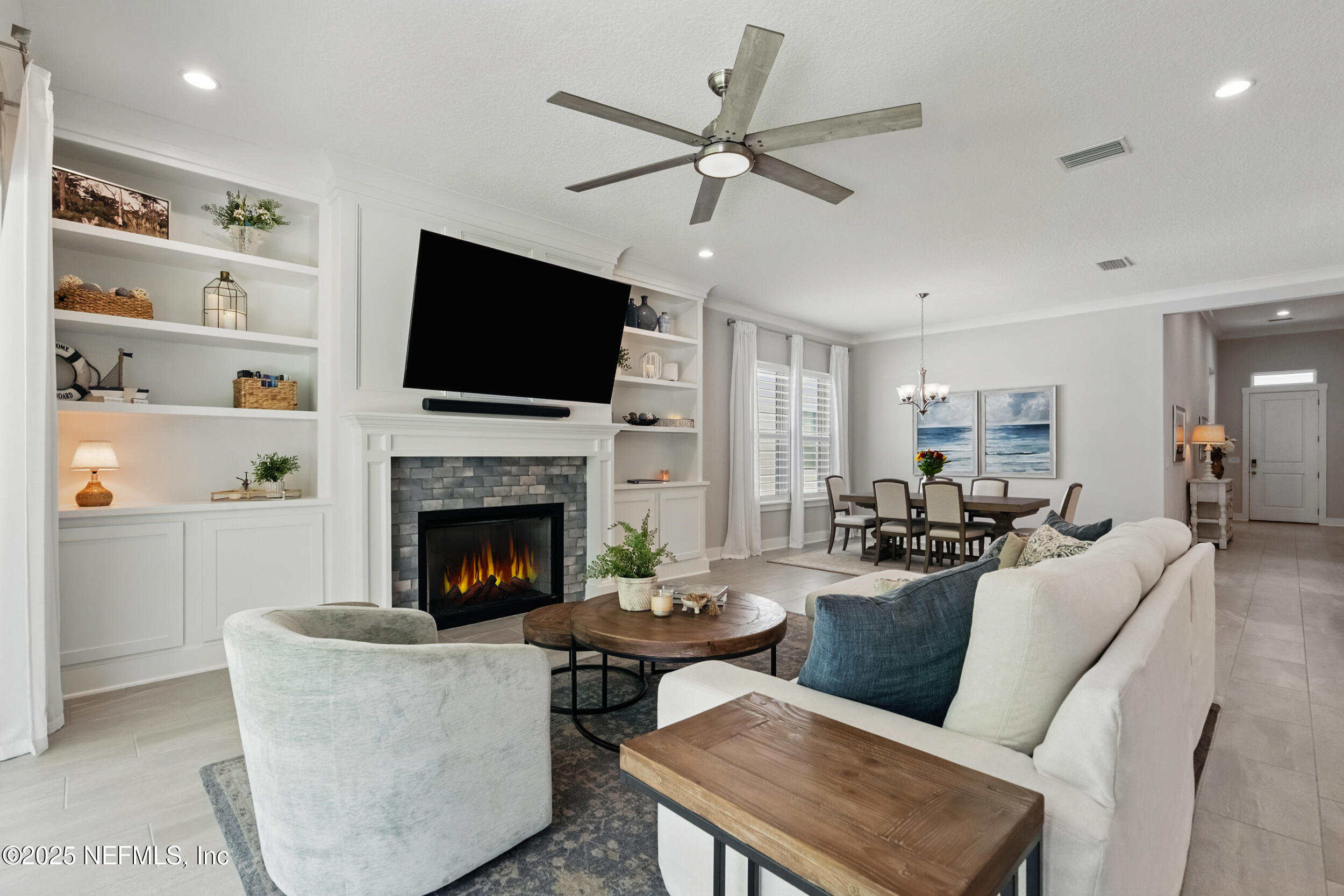 9918 Filament Boulevard Jacksonville, FL 32256 - Photo 19 of 106 a living room with furniture a fireplace and a flat screen tv