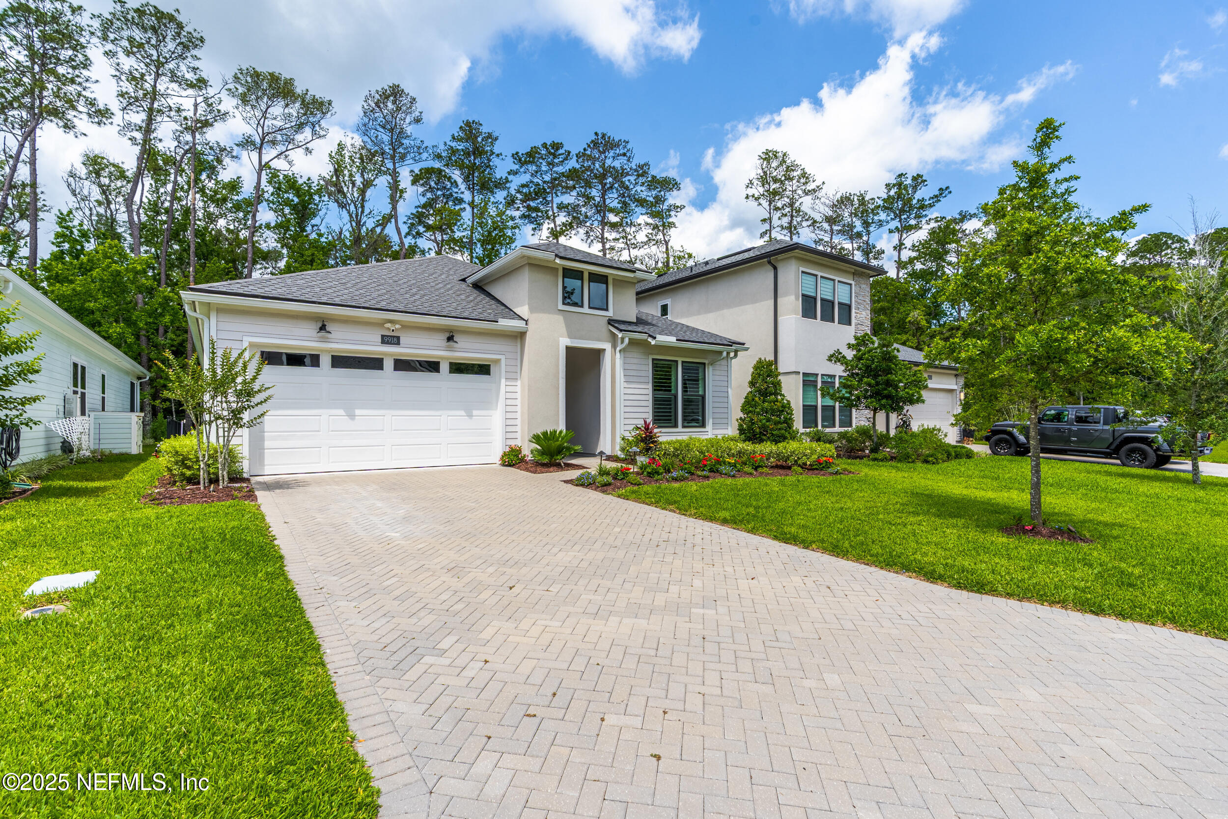 9918 Filament Boulevard Jacksonville, FL 32256 - Photo 2 of 106 a front view of a house with a yard and potted plants