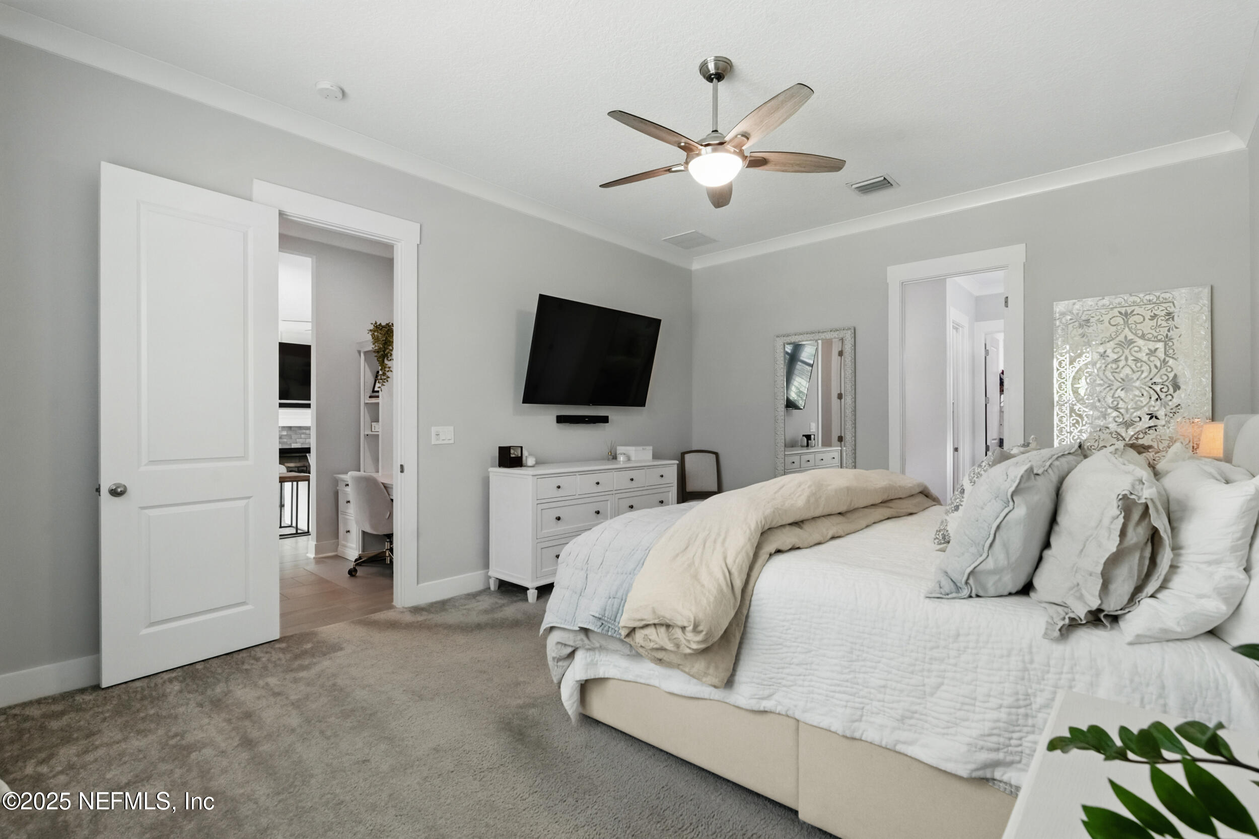 9918 Filament Boulevard Jacksonville, FL 32256 - Photo 29 of 106 a bedroom with a bed and a flat screen tv