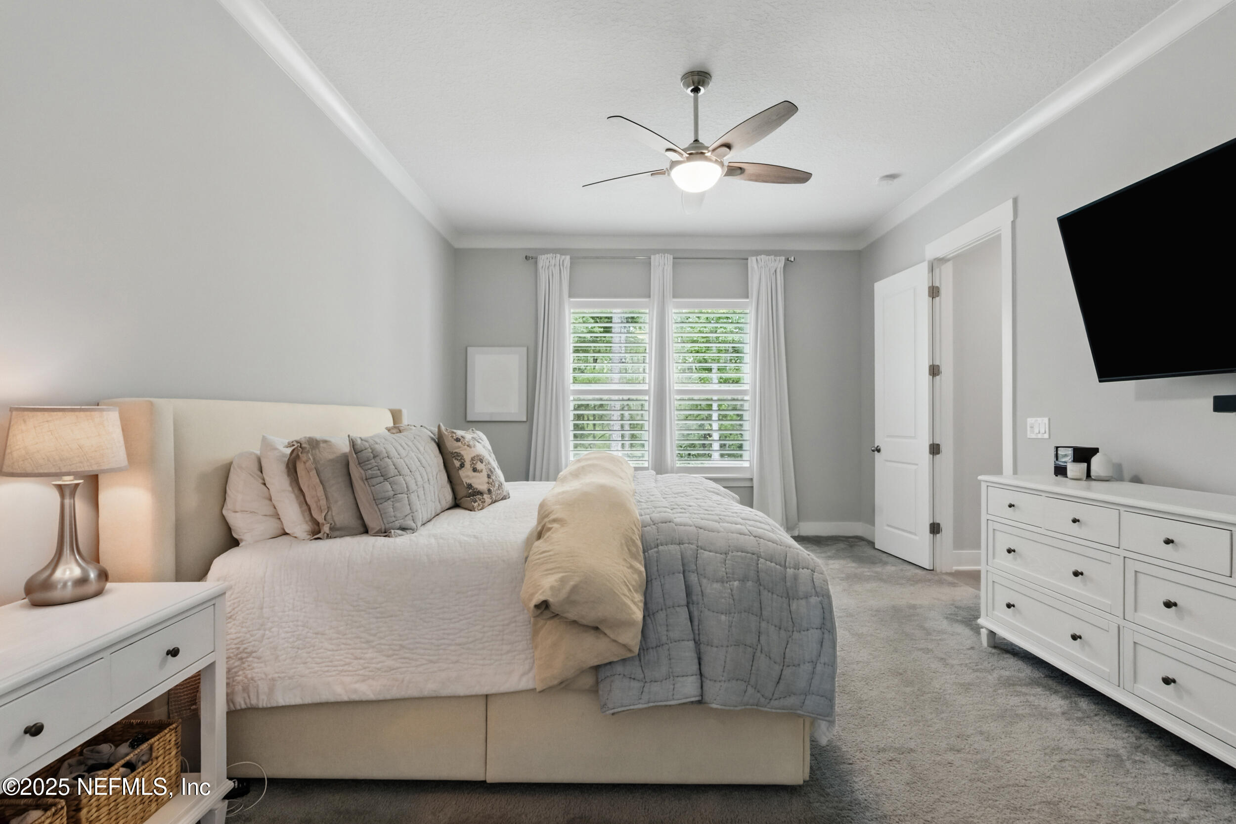 9918 Filament Boulevard Jacksonville, FL 32256 - Photo 30 of 106 a living room with a bed and flat screen tv
