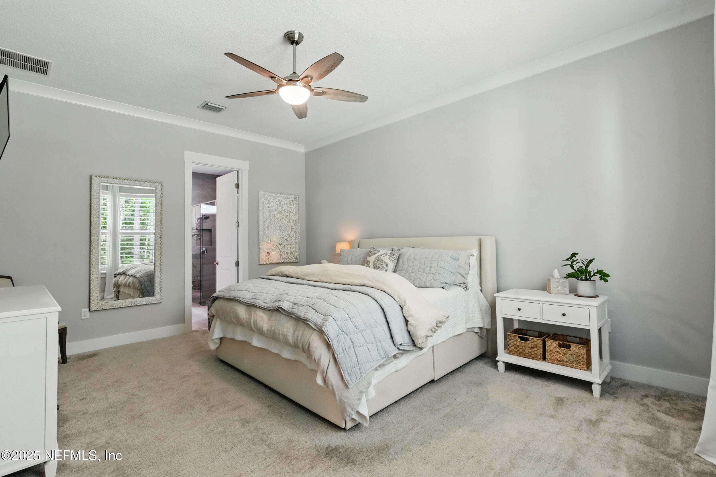 9918 Filament Boulevard Jacksonville, FL 32256 - Photo 31 of 106 a spacious bedroom with a bed and a ceiling fan