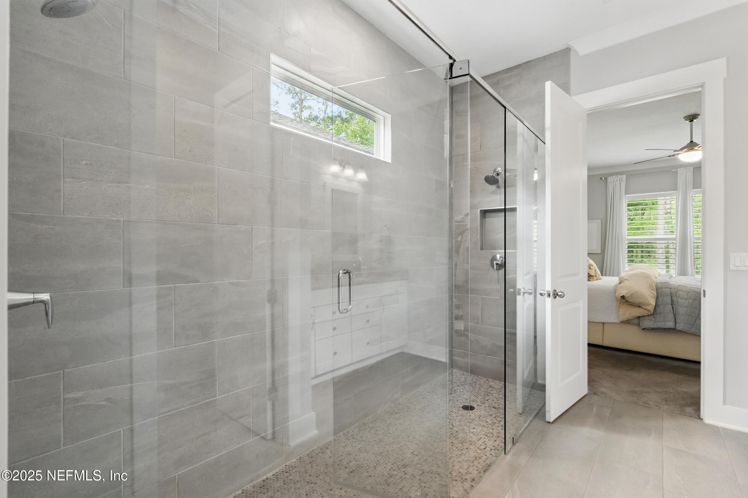 9918 Filament Boulevard Jacksonville, FL 32256 - Photo 32 of 106 a bathroom with a shower and a sink