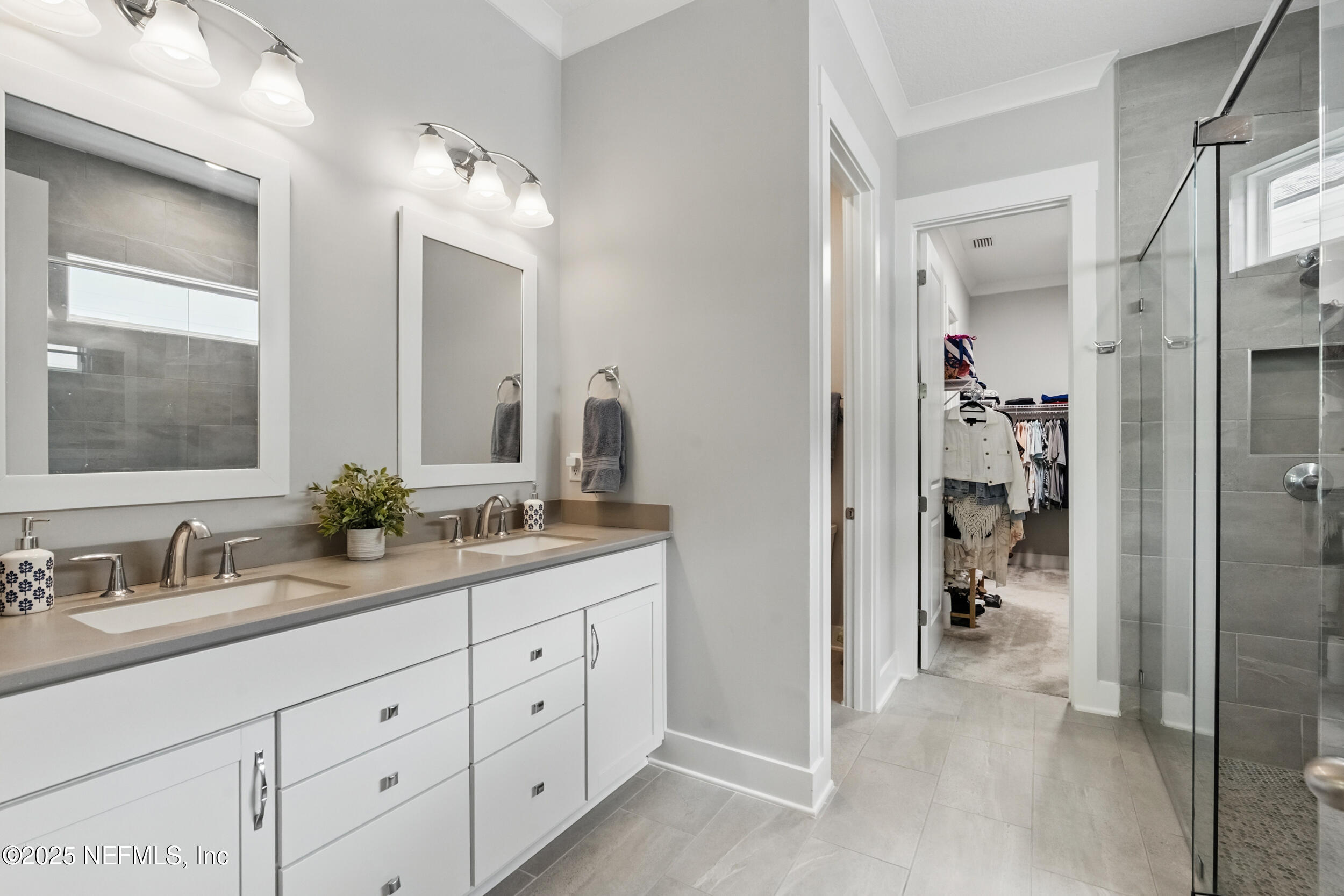 9918 Filament Boulevard Jacksonville, FL 32256 - Photo 33 of 106 a en suite bathroom with a granite countertop sink and a mirror