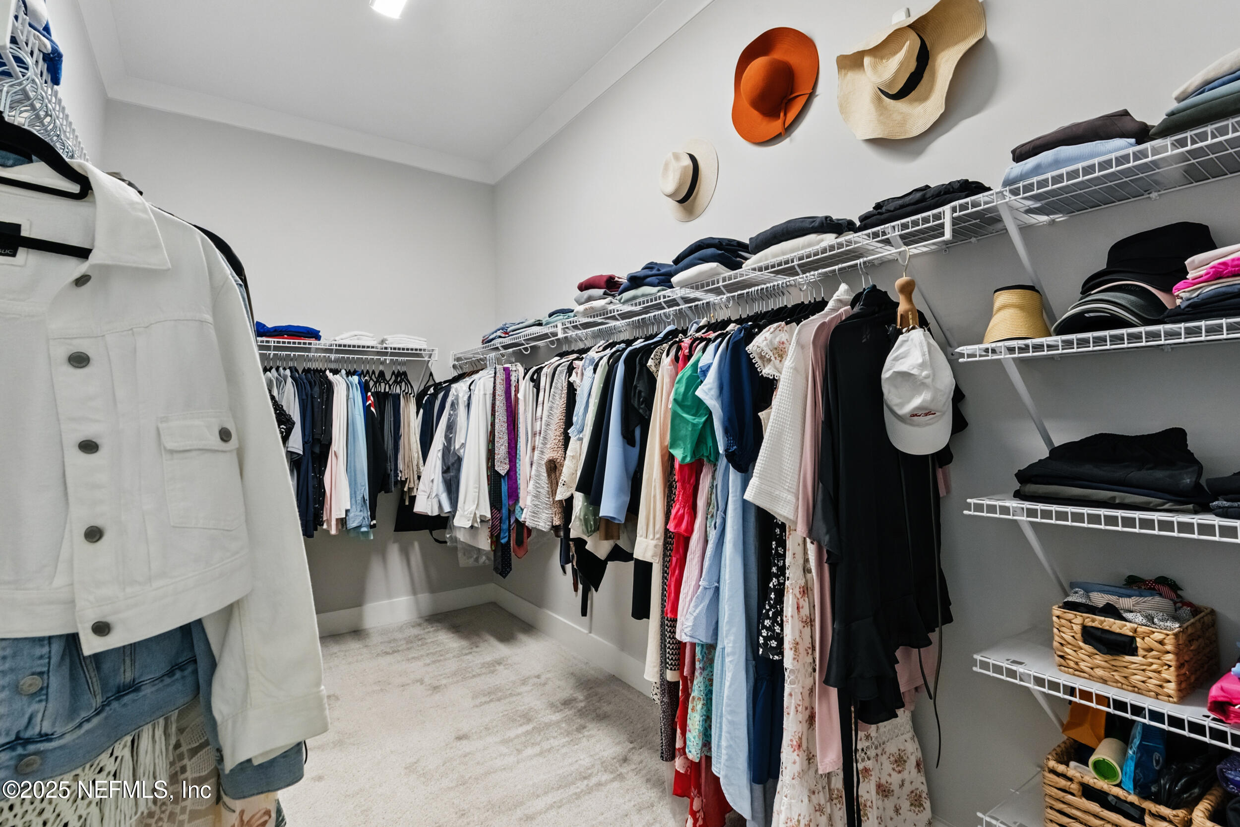9918 Filament Boulevard Jacksonville, FL 32256 - Photo 35 of 106 a view of walk in closet with clothes and shoes