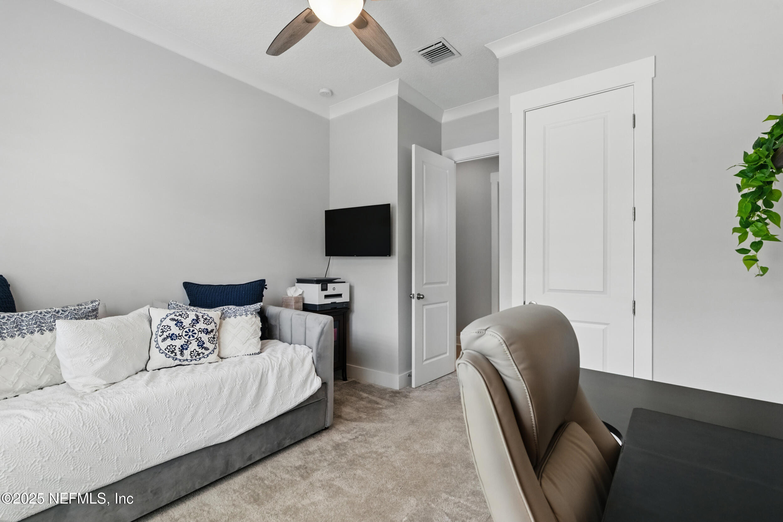 9918 Filament Boulevard Jacksonville, FL 32256 - Photo 39 of 106 a living room with furniture and a flat screen tv