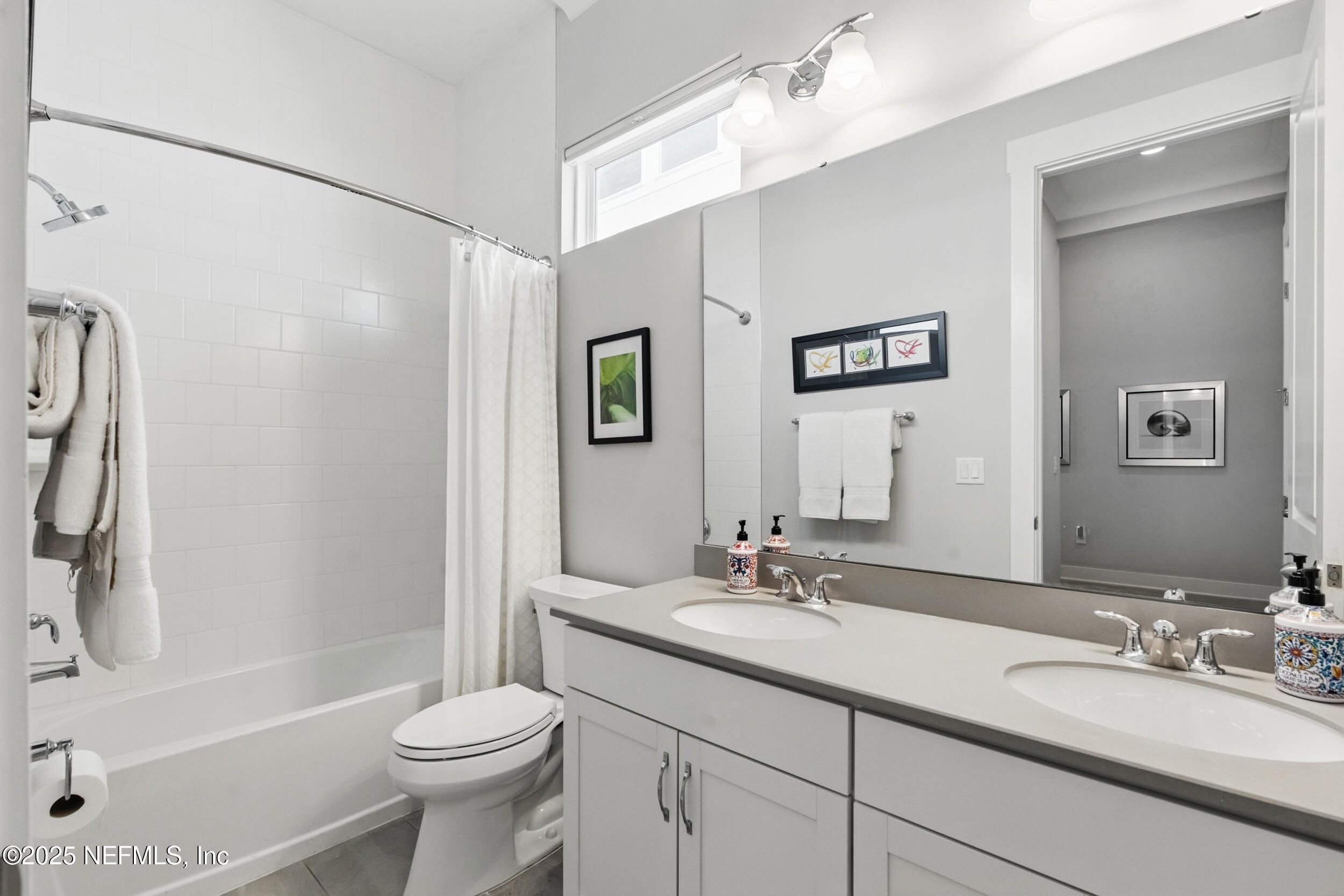 9918 Filament Boulevard Jacksonville, FL 32256 - Photo 40 of 106 a bathroom with a double vanity sink toilet mirror and shower