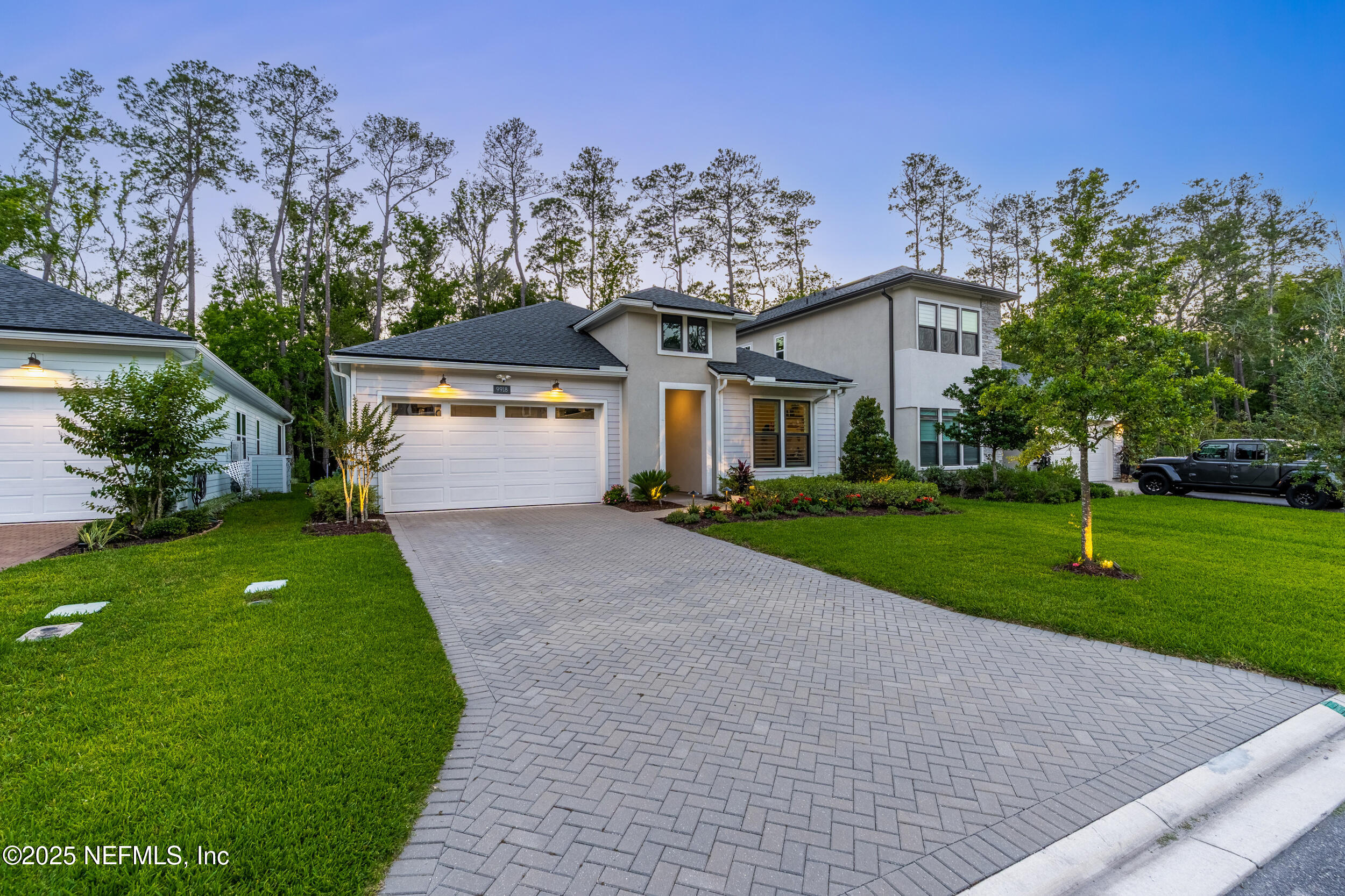 9918 Filament Boulevard Jacksonville, FL 32256 - Photo 69 of 106 a front view of a house with a yard and garage