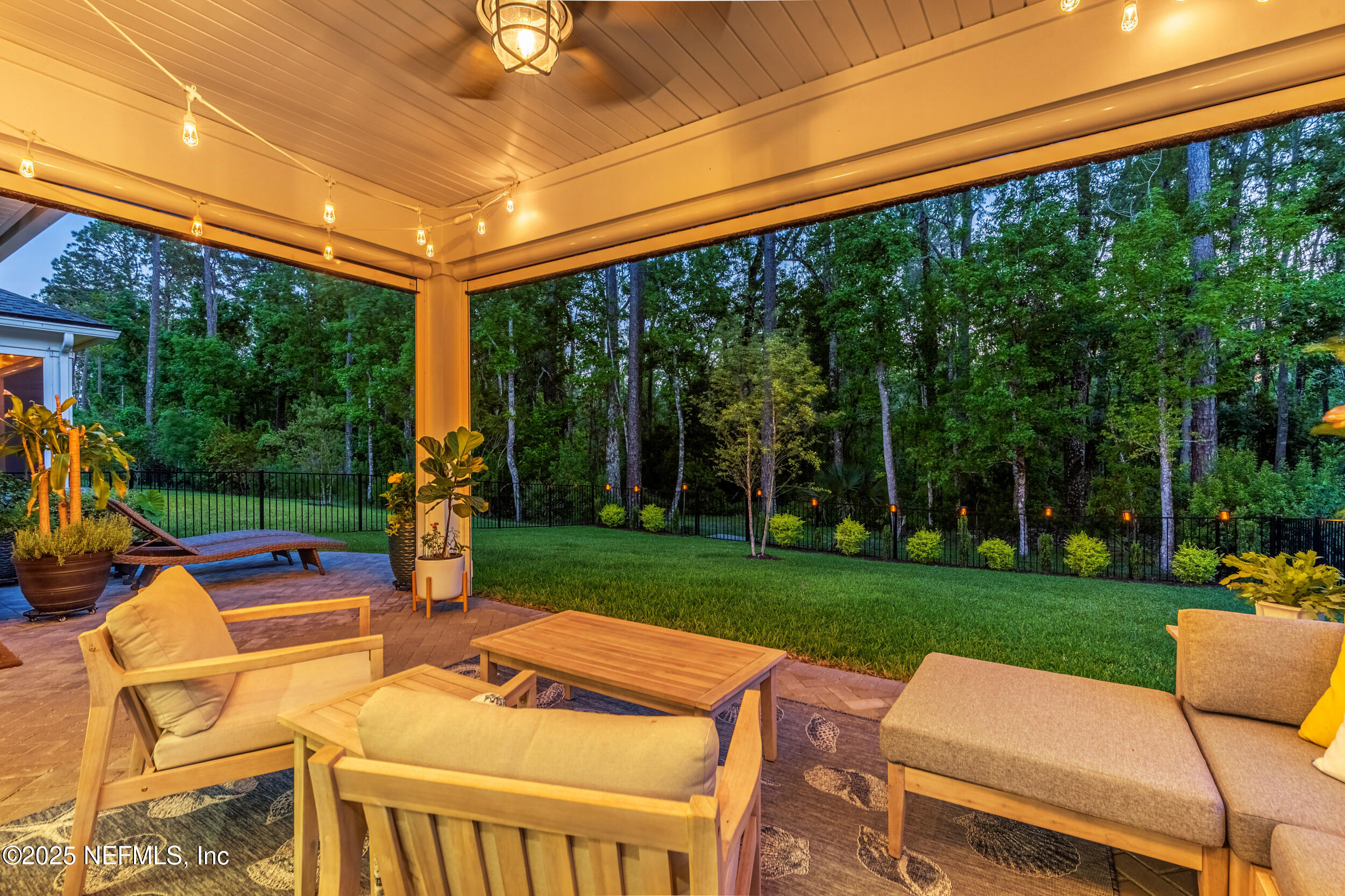 9918 Filament Boulevard Jacksonville, FL 32256 - Photo 80 of 106 a view of a patio with a table chairs and a backyard